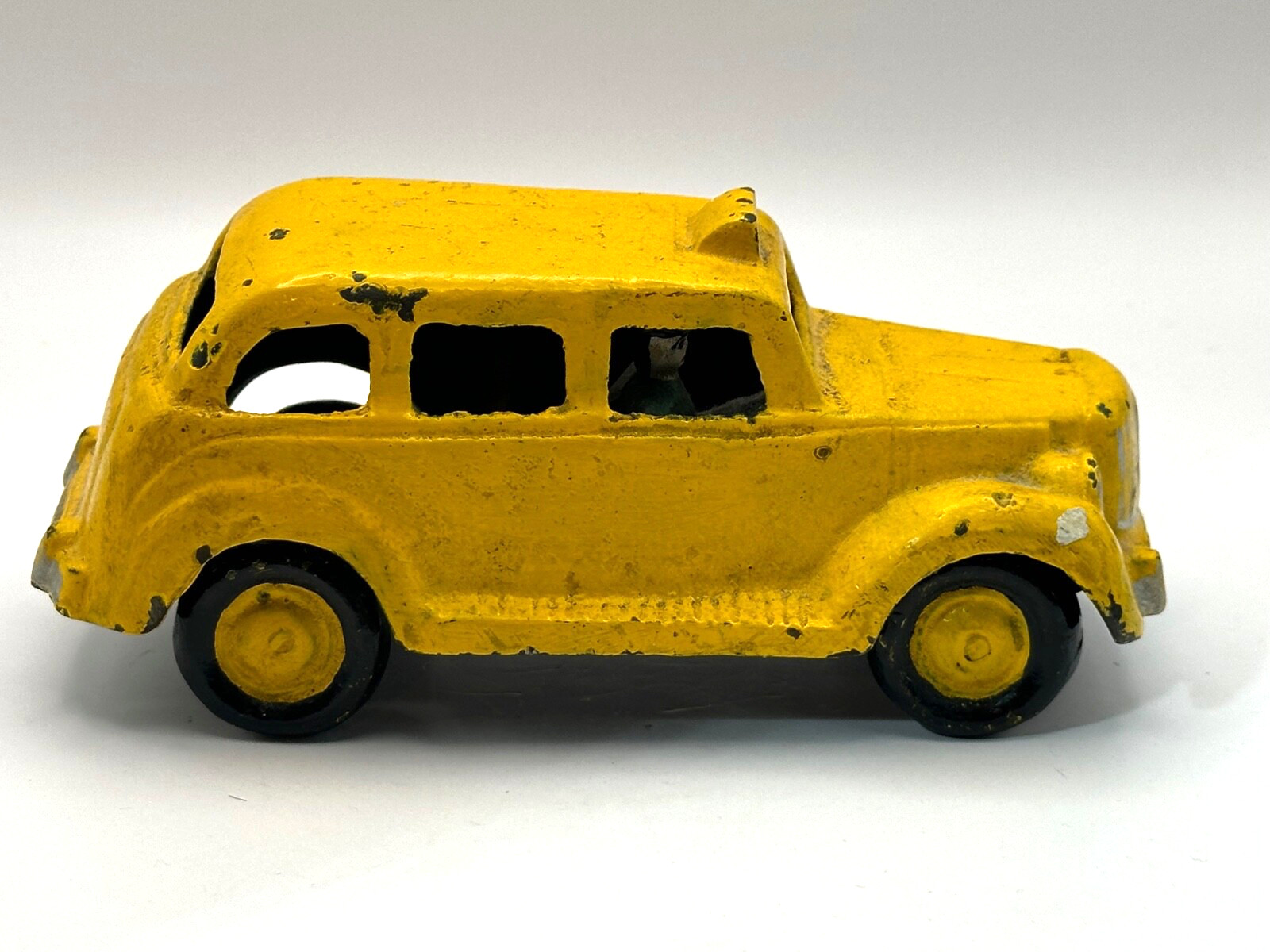 Vintage Cast Iron Taxi Driver Yellow Cab Toy with Man Driving